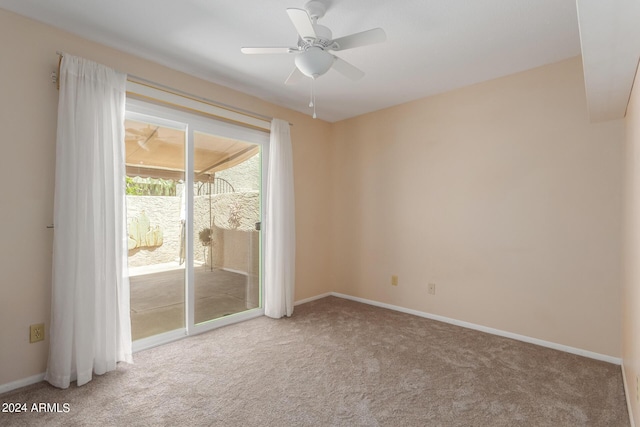 carpeted spare room with ceiling fan