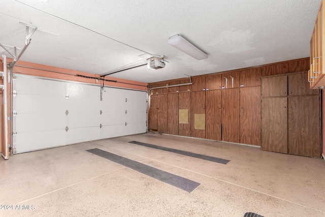 garage with wood walls and a garage door opener