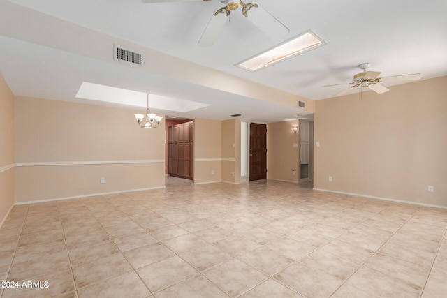 unfurnished room with ceiling fan with notable chandelier and light tile patterned flooring