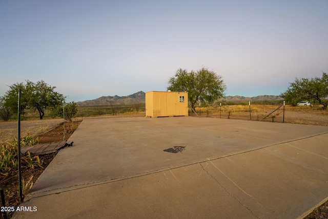 view of patio / terrace with a shed and a mountain view