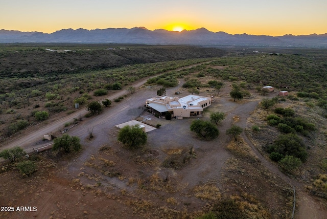 aerial view at dusk featuring a mountain view