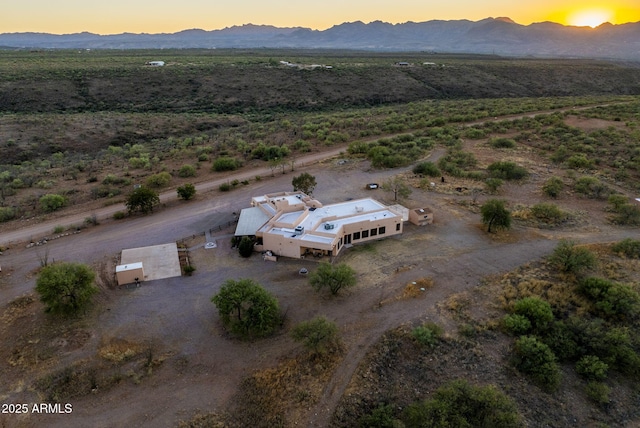 aerial view at dusk featuring a mountain view