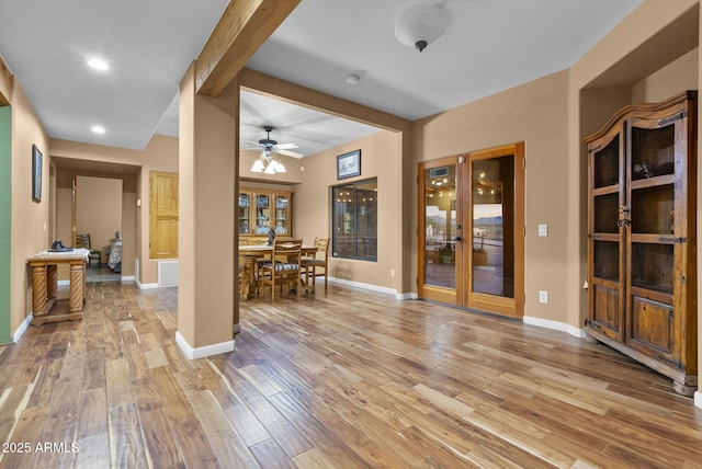 interior space with wood-type flooring and beamed ceiling