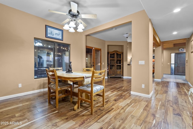 dining area featuring ceiling fan and wood-type flooring