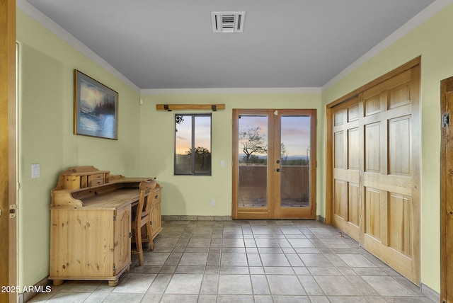 entryway featuring crown molding, light tile patterned floors, and french doors