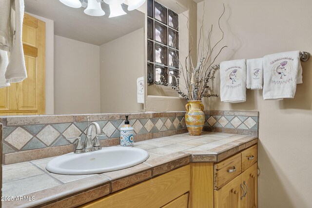 bathroom featuring vanity and decorative backsplash