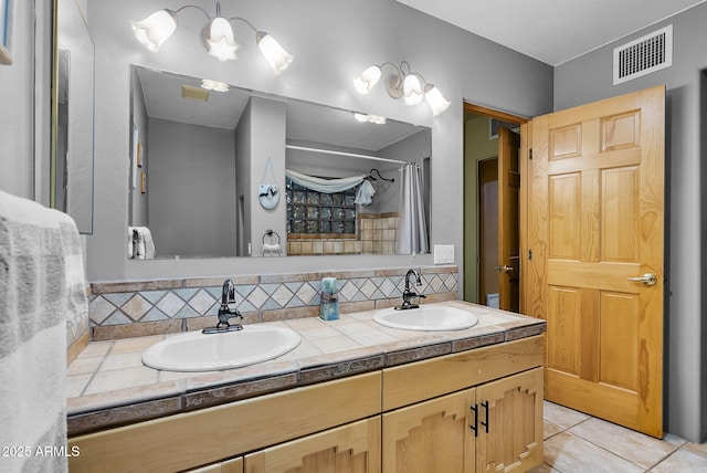 bathroom featuring tile patterned flooring, vanity, and decorative backsplash