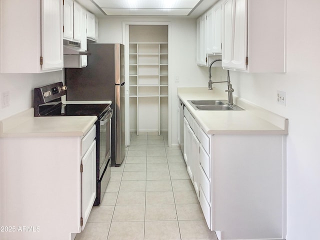 kitchen featuring range hood, sink, white cabinetry, stainless steel appliances, and light tile patterned floors