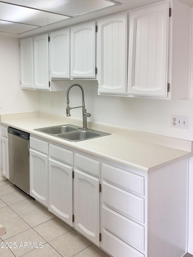 kitchen with light tile patterned flooring, dishwasher, white cabinets, and sink