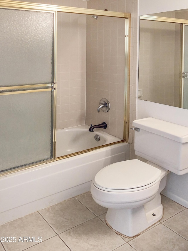 bathroom featuring tile patterned floors, shower / bath combination with glass door, and toilet