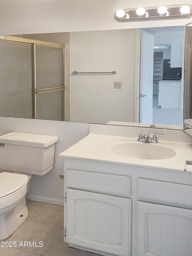 bathroom featuring tile patterned floors, toilet, an enclosed shower, and vanity