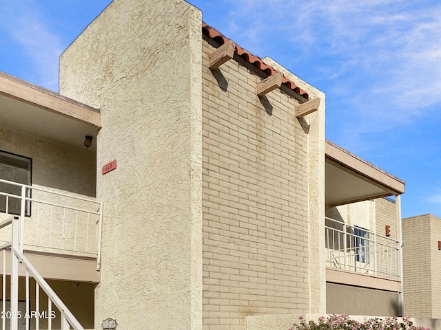 view of side of home with a balcony