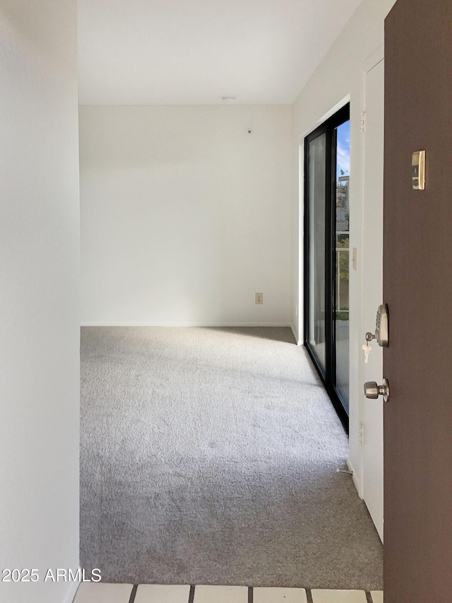 unfurnished room with light colored carpet