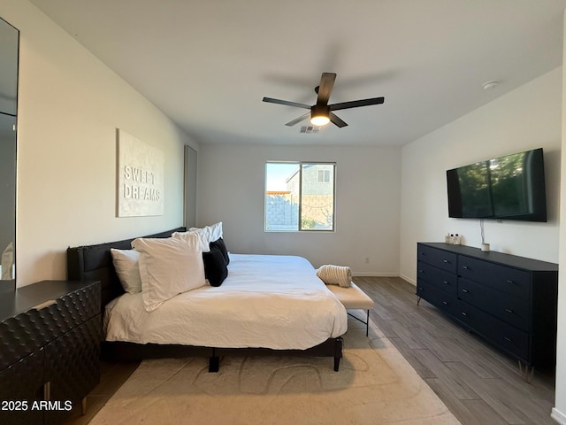 bedroom featuring hardwood / wood-style floors and ceiling fan