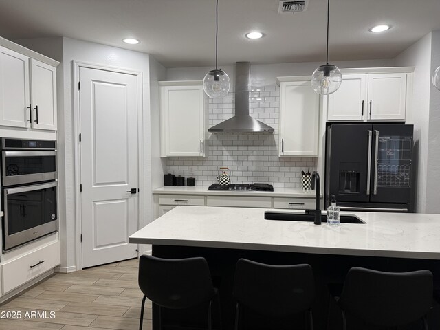 13342 W Lariat Ln, Peoria, AZ 85383 - kitchen with pendant lighting, sink, wall chimney exhaust hood, and appliances with stainless steel finishes