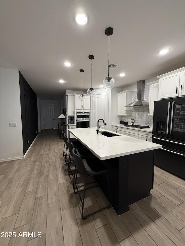 13342 W Lariat Ln, Peoria, AZ 85383 - kitchen with stainless steel appliances, a spacious island, pendant lighting, and wall chimney exhaust hood