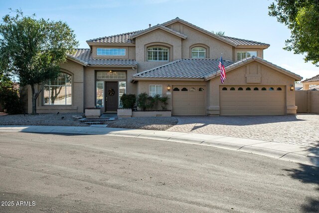5281 W Quail Ave, Glendale, AZ 85308 - view of front of property with stucco siding, a garage, a tiled roof, decorative driveway, and fence