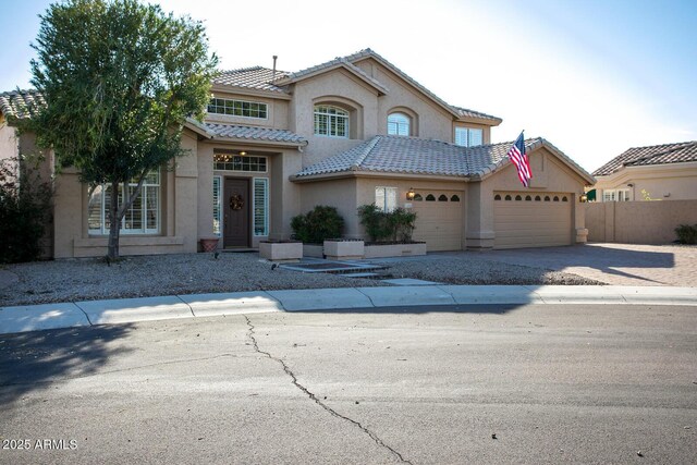5281 W Quail Ave, Glendale, AZ 85308 - mediterranean / spanish-style house featuring a garage, stucco siding, driveway, fence, and a tiled roof