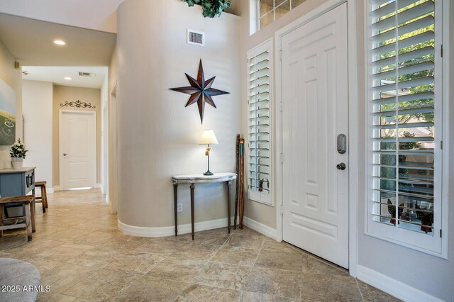 5281 W Quail Ave, Glendale, AZ 85308 - foyer featuring baseboards, light stone finish floors, and recessed lighting