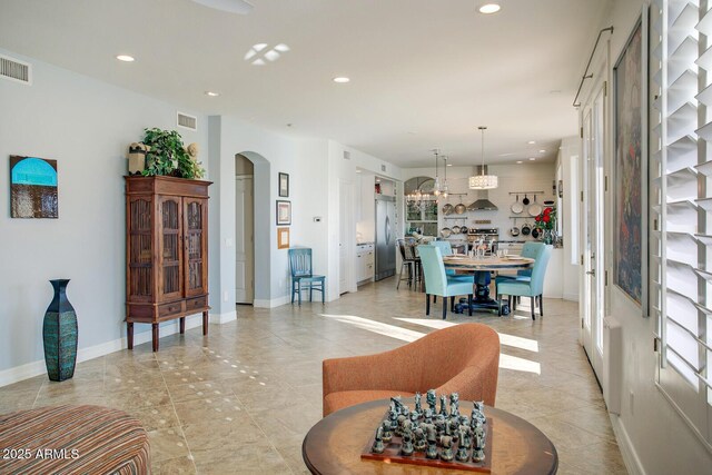 5281 W Quail Ave, Glendale, AZ 85308 - living area with arched walkways, recessed lighting, baseboards, and light tile patterned floors