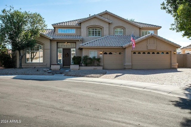 5281 W Quail Ave, Glendale, AZ 85308 - view of front of property featuring stucco siding, a garage, a tiled roof, decorative driveway, and fence