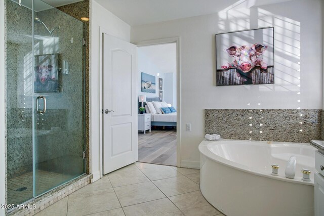 5281 W Quail Ave, Glendale, AZ 85308 - ensuite bathroom with a stall shower, tile patterned flooring, and a garden tub