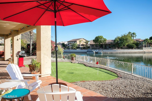 5281 W Quail Ave, Glendale, AZ 85308 - view of patio / terrace featuring an area to practice putting, fence, and a water view