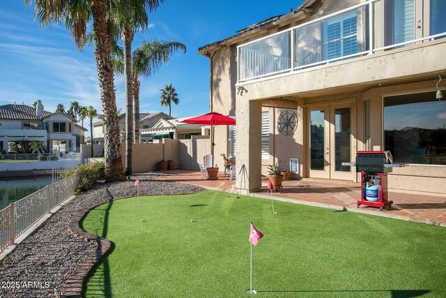5281 W Quail Ave, Glendale, AZ 85308 - view of yard with a putting green, french doors, a balcony, and a patio