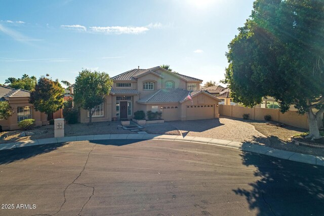 5281 W Quail Ave, Glendale, AZ 85308 - mediterranean / spanish house featuring an attached garage, driveway, fence, stucco siding, and a tiled roof