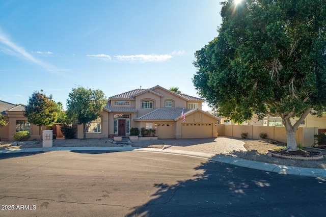 5281 W Quail Ave, Glendale, AZ 85308 - mediterranean / spanish-style home featuring a garage, fence, driveway, stucco siding, and a tile roof