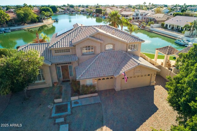 5281 W Quail Ave, Glendale, AZ 85308 - view of front facade with a tile roof, a garage, a water view, stucco siding, and a residential view