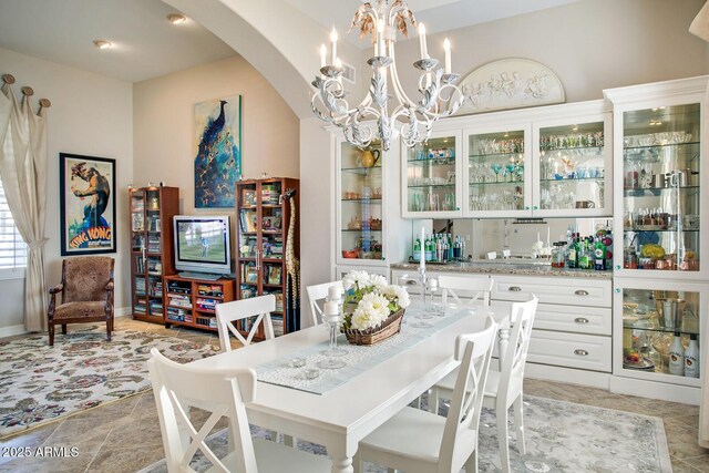 5281 W Quail Ave, Glendale, AZ 85308 - dining area with arched walkways, a chandelier, and wet bar