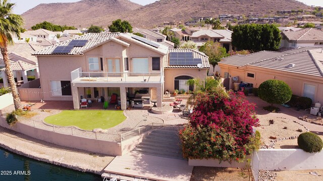 5281 W Quail Ave, Glendale, AZ 85308 - back of house featuring a balcony, a fenced backyard, a patio, and roof mounted solar panels