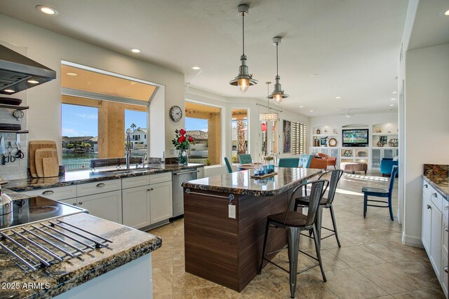 5281 W Quail Ave, Glendale, AZ 85308 - kitchen with dishwasher, recessed lighting, healthy amount of natural light, white cabinets, and dark stone countertops