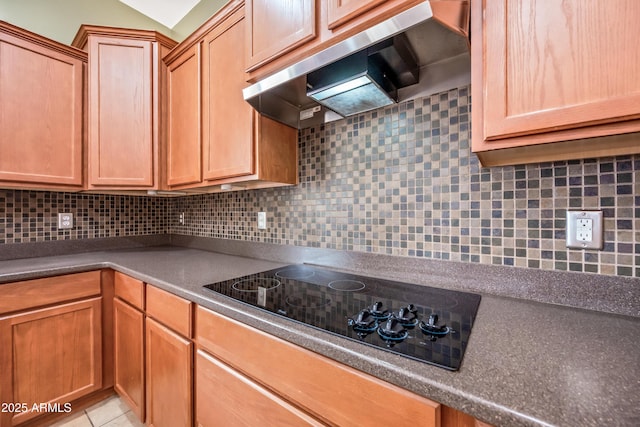 19245 W Pasadena Ave, Litchfield Park, AZ 85340 - kitchen with under cabinet range hood, black electric stovetop, decorative backsplash, and dark countertops