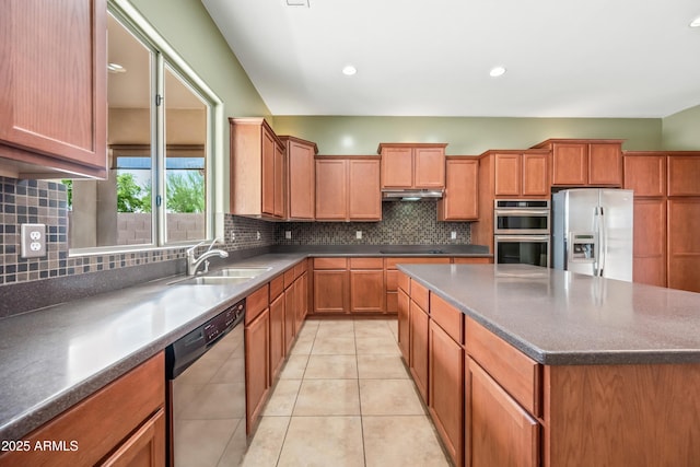 19245 W Pasadena Ave, Litchfield Park, AZ 85340 - kitchen featuring stainless steel appliances, under cabinet range hood, a center island, a sink, and tasteful backsplash