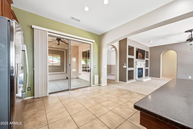 19245 W Pasadena Ave, Litchfield Park, AZ 85340 - unfurnished living room with a ceiling fan, arched walkways, light tile patterned floors, and recessed lighting