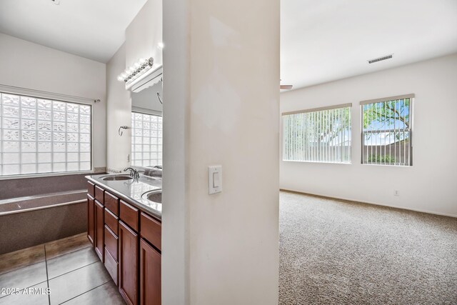 19245 W Pasadena Ave, Litchfield Park, AZ 85340 - full bathroom featuring healthy amount of natural light, double vanity, and a bathtub