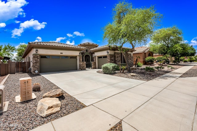 19245 W Pasadena Ave, Litchfield Park, AZ 85340 - mediterranean / spanish home with an attached garage, stone siding, concrete driveway, and stucco siding