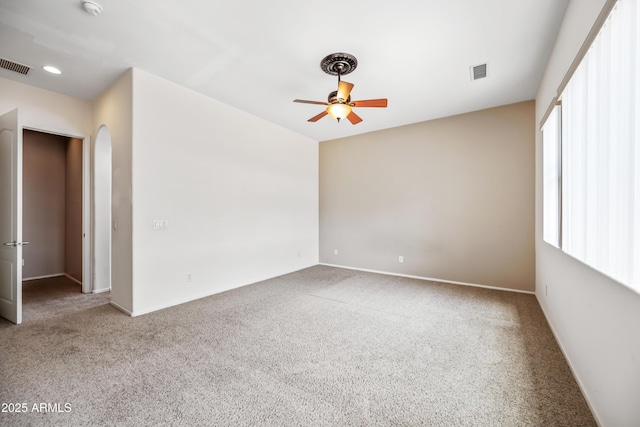 19245 W Pasadena Ave, Litchfield Park, AZ 85340 - unfurnished room featuring a ceiling fan, carpet floors, and arched walkways