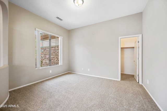 19245 W Pasadena Ave, Litchfield Park, AZ 85340 - unfurnished bedroom with carpet, a spacious closet, baseboards, and a closet