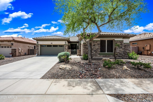 19245 W Pasadena Ave, Litchfield Park, AZ 85340 - view of front of house featuring an attached garage, stone siding, stucco siding, driveway, and a tile roof