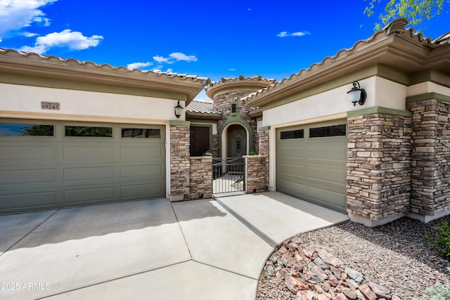 19245 W Pasadena Ave, Litchfield Park, AZ 85340 - mediterranean / spanish-style home with stone siding, driveway, a garage, and a tile roof