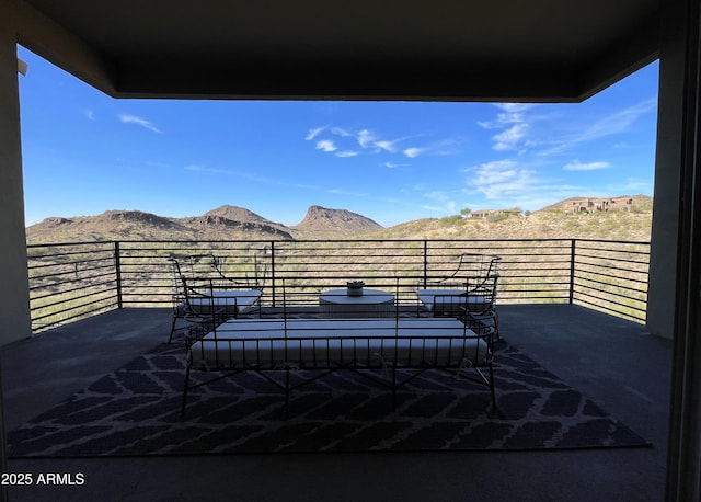 view of patio / terrace with a mountain view and a balcony