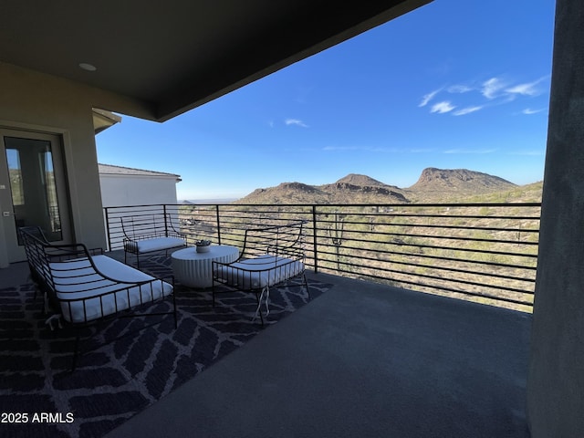 view of patio / terrace featuring a mountain view and a balcony