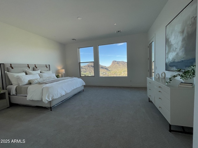 bedroom with carpet flooring and a mountain view