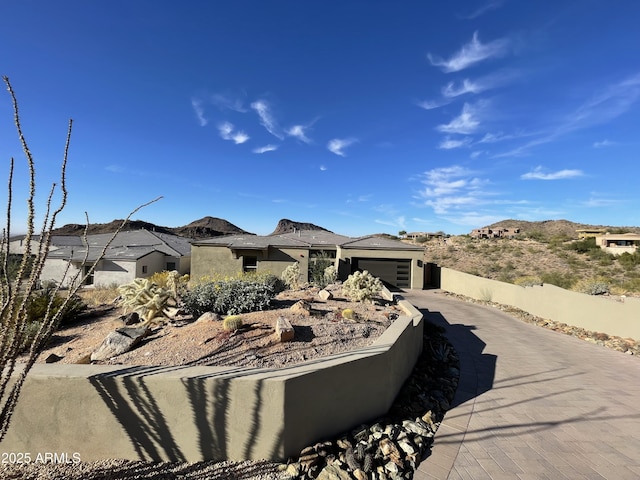 view of front of property with a mountain view and a garage