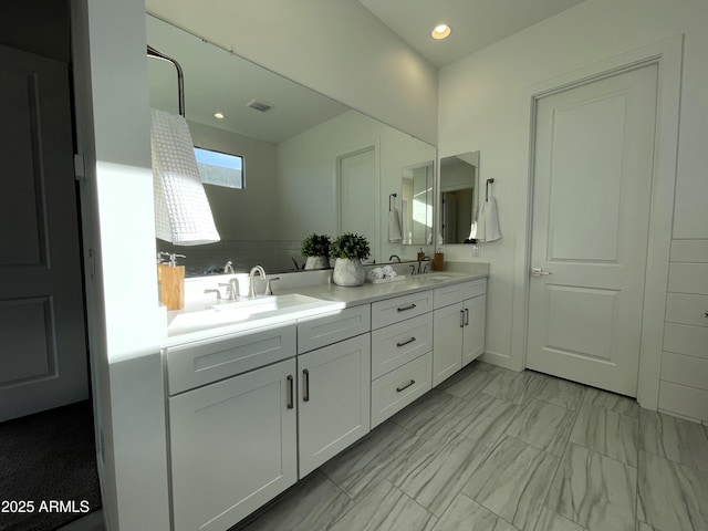 bathroom featuring vanity and a skylight