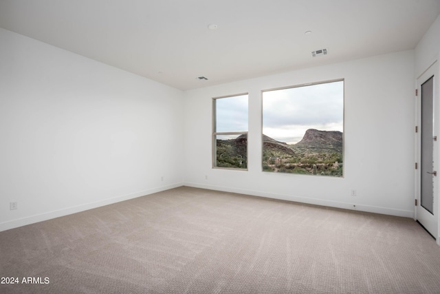 empty room with light colored carpet