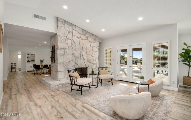 13620 N 80th Pl, Scottsdale, AZ 85260 - sitting room with wood finished floors, french doors, recessed lighting, baseboards, and a stone fireplace